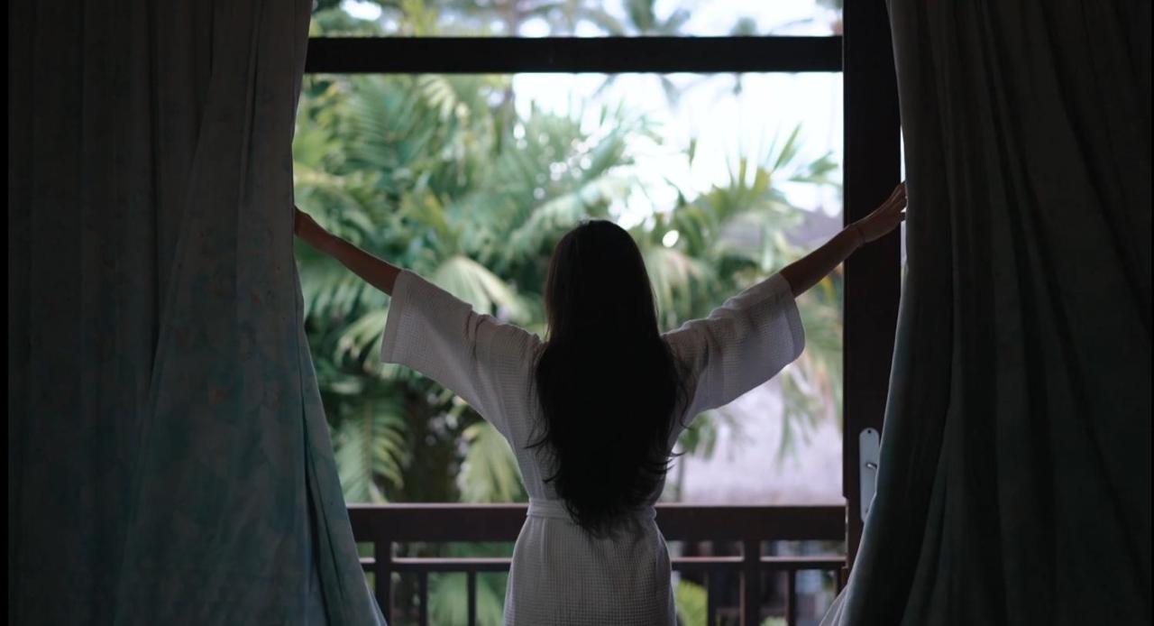 The Patra Bali Resort & Villas - Chse Certified Kuta Lombok Exterior foto A woman opening the curtains in the morning